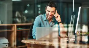 Travel agent inquiring about commission payment over the phone in a cafe